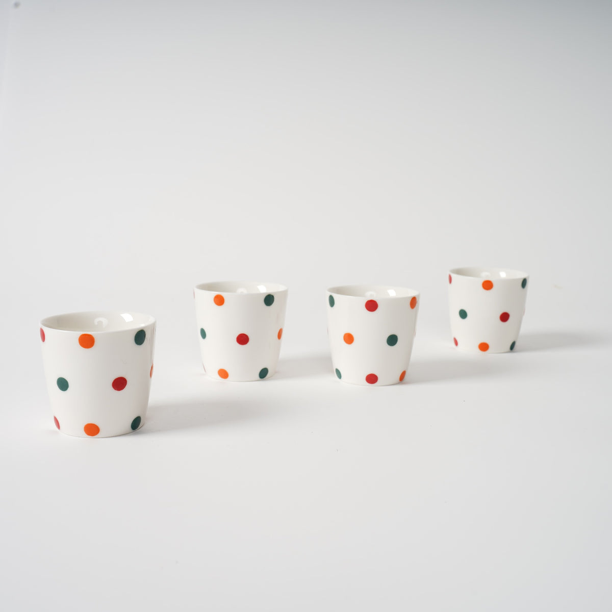 Handmade polka dot ceramic tea set with teapot and matching cups