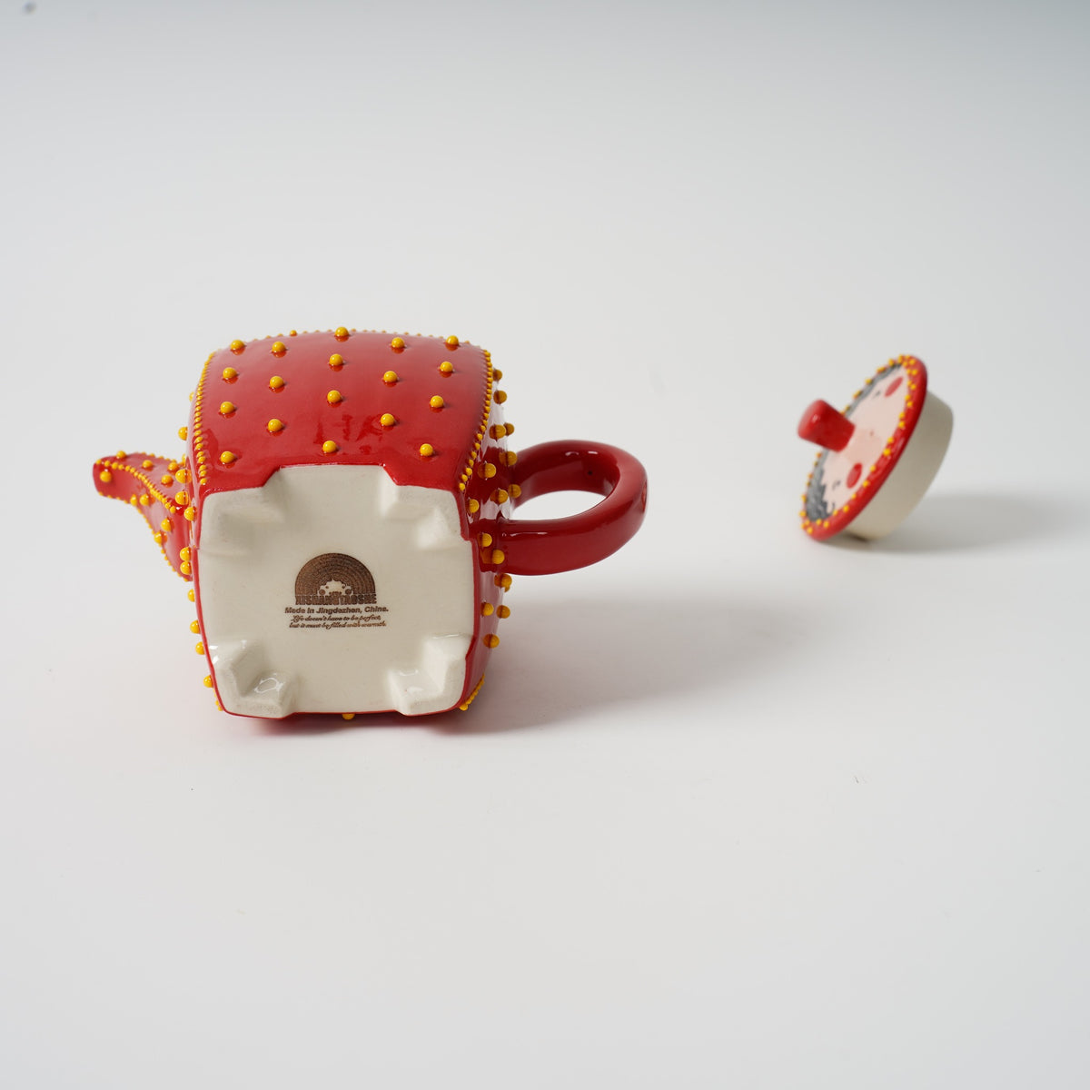 Handmade red square ceramic teapot detail