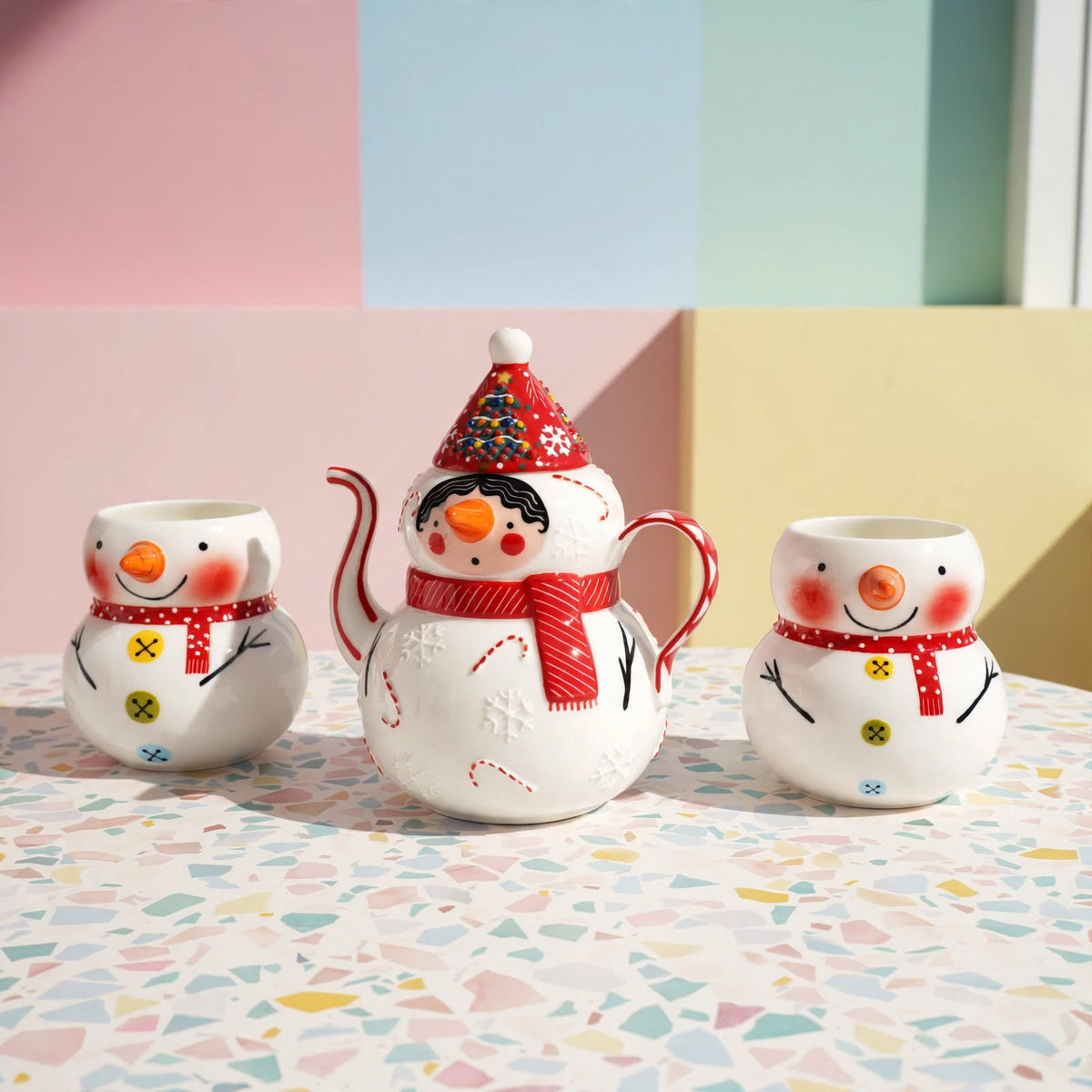 Hand-painted snowman ceramic tea set with teapot and two matching cups