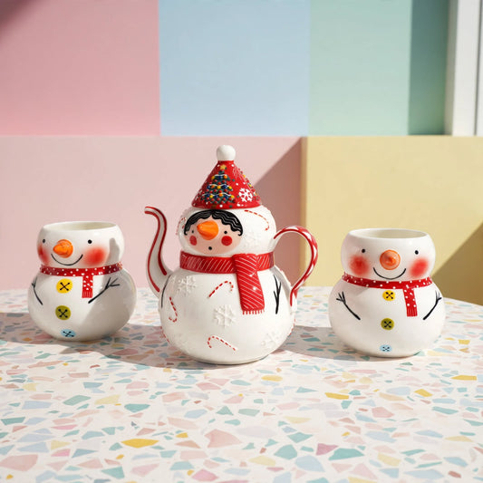 Hand-painted snowman ceramic tea set with teapot and two matching cups
